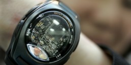 An employee of Japan's AR'S Corporation shows-off the company's wrist-type wearable miniature sensing module 