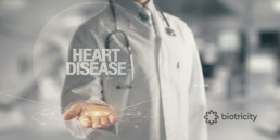 Physician holding out a digital representation that reads Heart Disease.