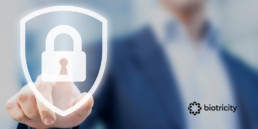 Person touching an icon of a shield with a lock on it to signify security