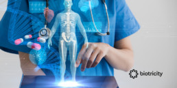 A nurse holds a tablet from which 3D healthcare icons emerge, including a human body, a DNA strand, and pills.